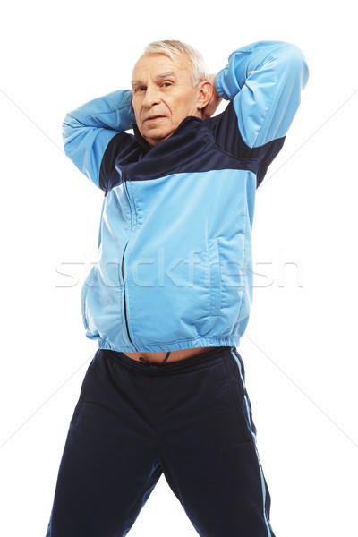 Senior man in training suit doing warm-up stretching exercises  Stock photo © Nejron