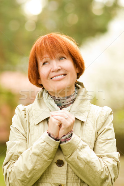 Beautiful smiling middle-aged woman outdoors Stock photo © Nejron