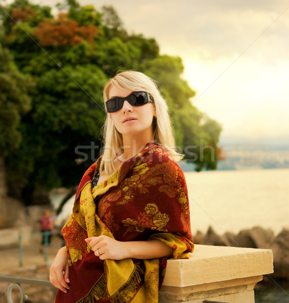 Beautiful young woman near the ocean at sunset Stock photo © Nejron