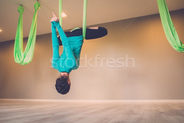 Young woman performing antigravity yoga exercise  Stock photo © Nejron