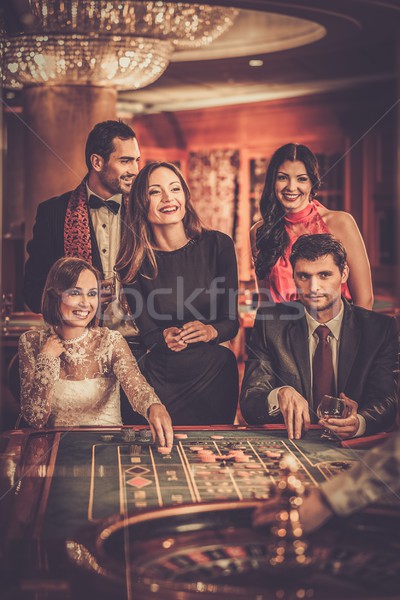 Group of stylish people playing in a casino Stock photo © Nejron