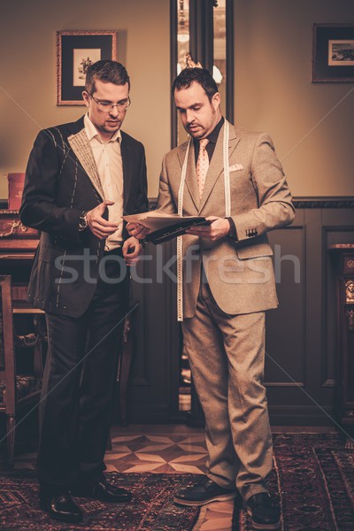 Tailor and client choosing cloth and buttons for custom made suit  Stock photo © Nejron