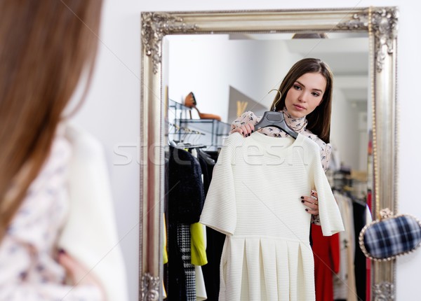 Young woman choosing clothes in a showroom  Stock photo © Nejron