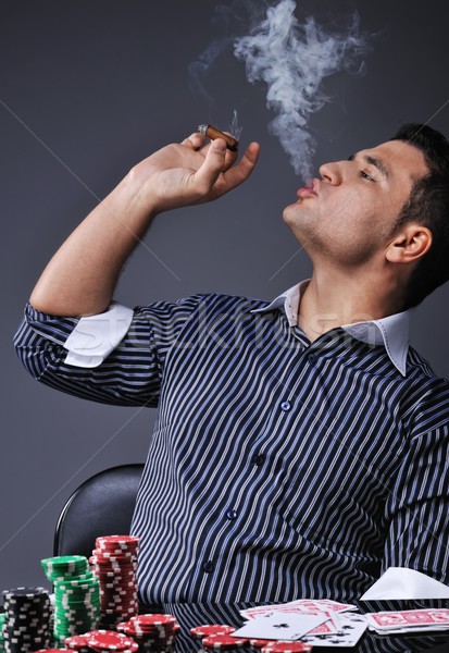 Portrait of a young gangster smoking and playing poker Stock photo © Nejron