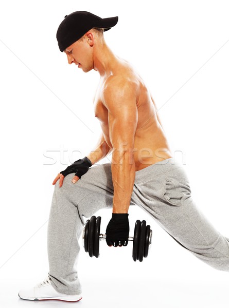 Stock photo: Handsome young muscular man exercising with dumbbells