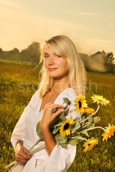 Young beautiful woman with a bouquet of sunflowers in thr field  Stock photo © Nejron
