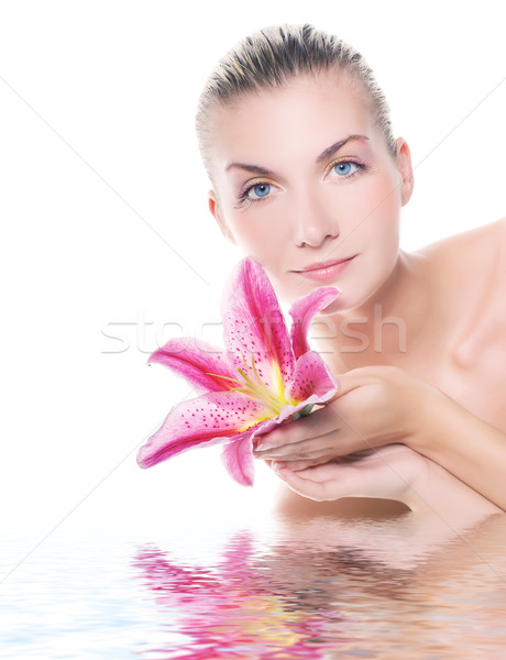Beautiful woman with lily flower reflected in water Stock photo © Nejron
