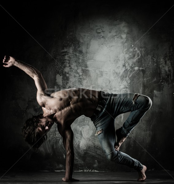 Young b-boy man with naked torso doing brake dancing movements  Stock photo © Nejron