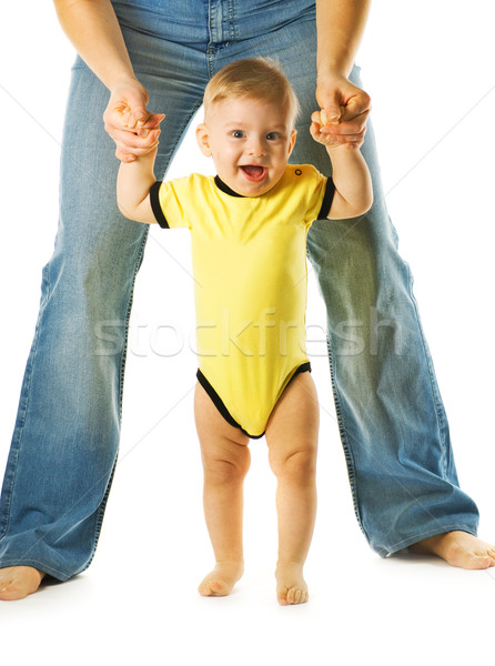 Adorable baby making first steps with mother's help Stock photo © Nejron