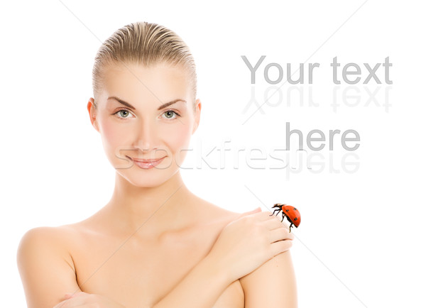 Stock photo: Ladybug sitting on beautiful woman's hand. Isolated on white bac