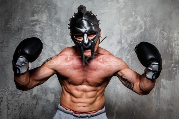 молодым человеком боксерские перчатки гладиатор шлема позируют спорт Сток-фото © Nejron