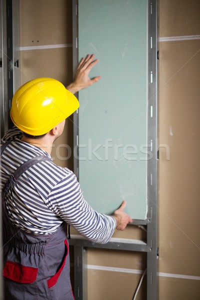 Builder with plasterboard in new building interior  Stock photo © Nejron