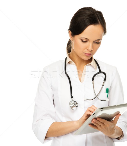 Young brunette doctor woman taking notes on tablet pc  Stock photo © Nejron