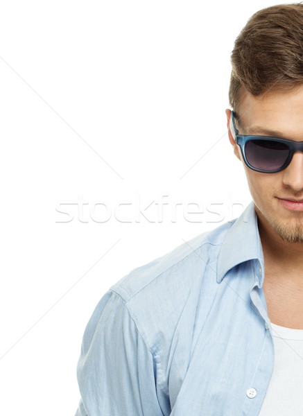 Stylish man in blue shirt wearing sunglasses isolated on white Stock photo © Nejron