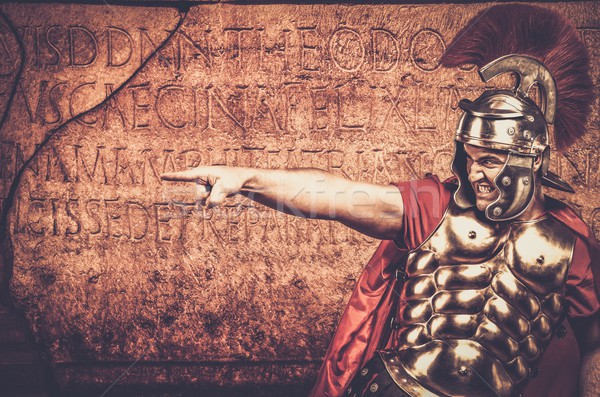 Roman legionary soldier in front of  wall with ancient writing  Stock photo © Nejron