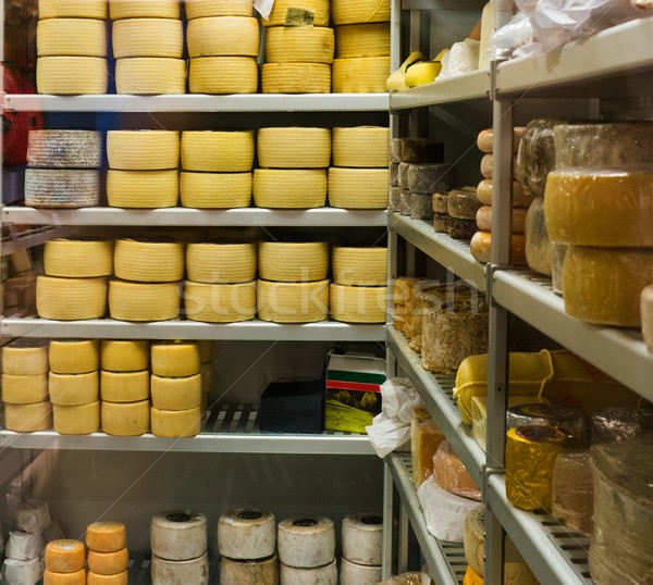 Shelves full of different cheese Stock photo © Nejron