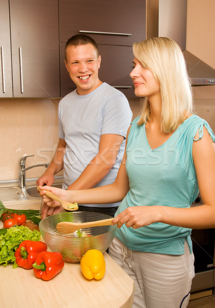 Young couple making vegetable salad in the kitchen Stock photo © Nejron