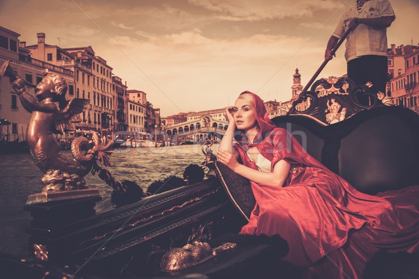 Beautiful woman in red cloak riding on gondola Stock photo © Nejron