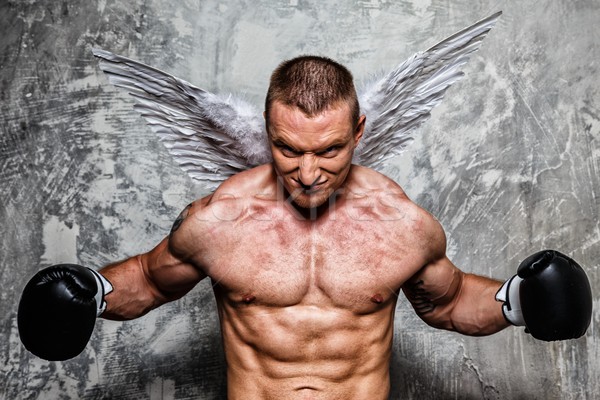 Young boxer with angel wings behind his back posing  Stock photo © Nejron