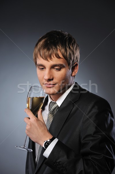 Young handsome businessman with a glass of champagne Stock photo © Nejron