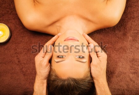 Stock photo: Young woman having face massage in a spa salon