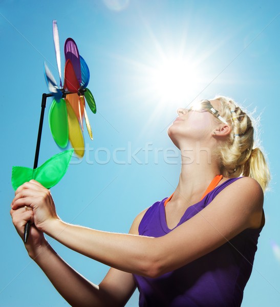 Beautiful girl with a flower against blue sky Stock photo © Nejron