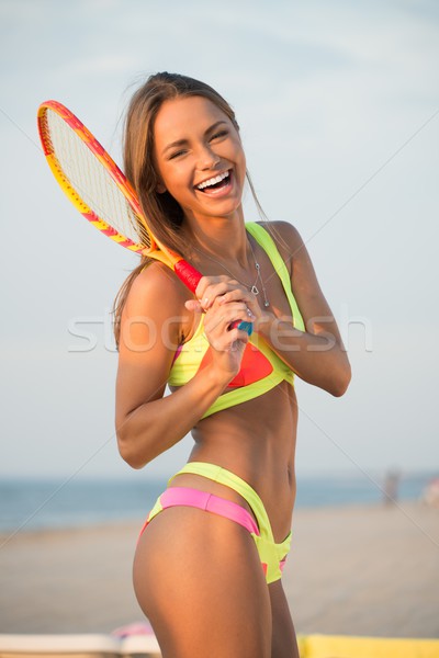 Young girl in swimming suit on a beach with racquet  Stock photo © Nejron