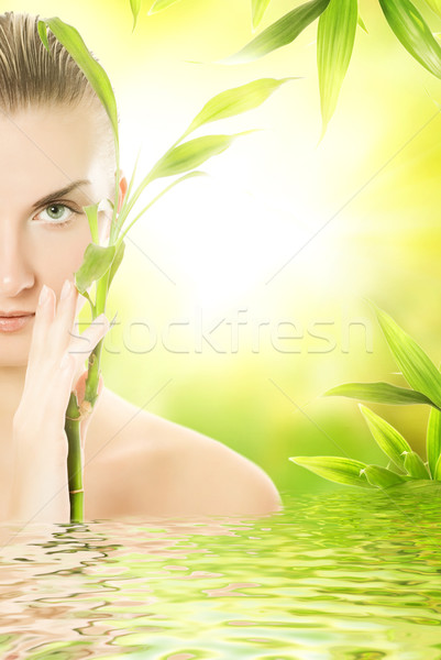 Belo mulher jovem bambu planta prestados água Foto stock © Nejron