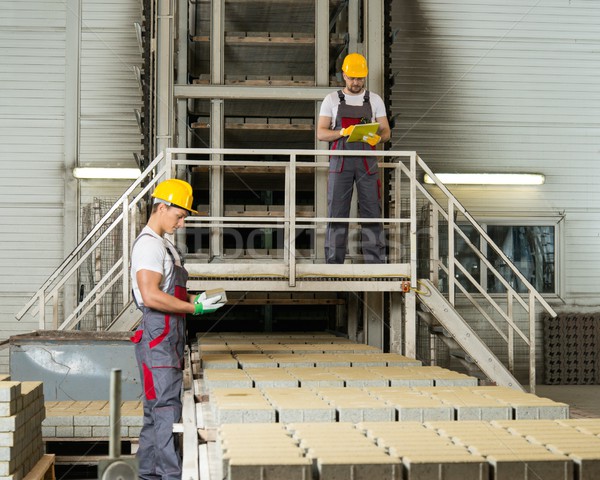 Worker and foreman in a safety hats on a factory   Stock photo © Nejron