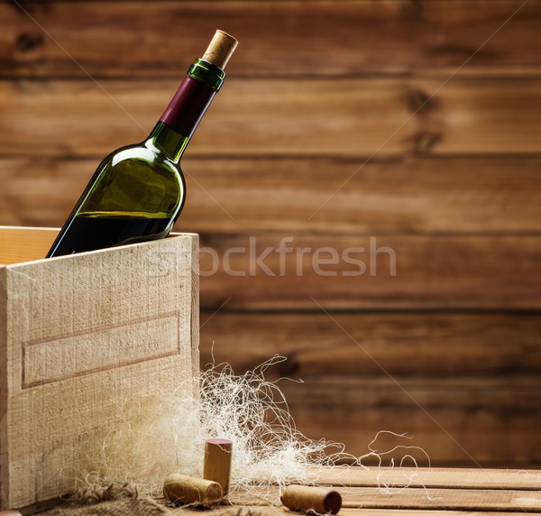 Bottle of wine in box in wooden interior  Stock photo © Nejron