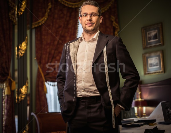 Middle-aged man trying on custom made suit in luxury vintage interior  Stock photo © Nejron