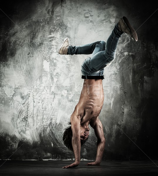 Young b-boy man with naked torso doing brake dancing movements  Stock photo © Nejron