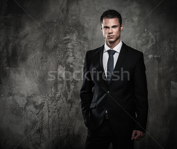 Well-dressed man in black suit against grunge wall  Stock photo © Nejron