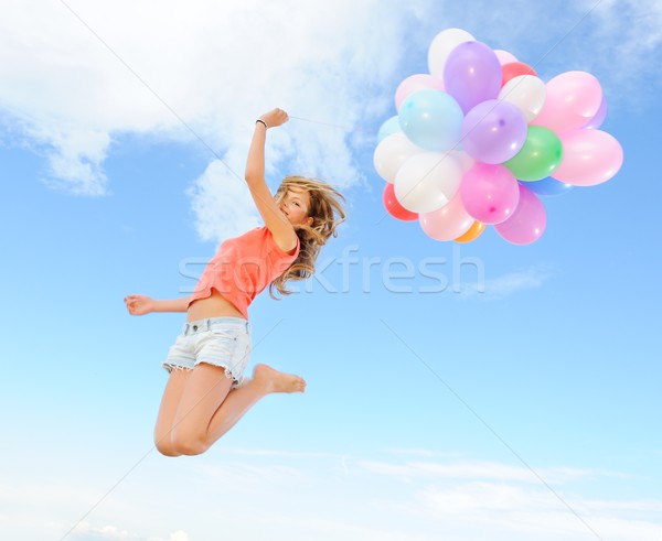 Stock photo: Happy girl with colorful balloons 