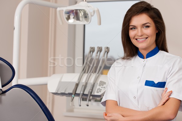 Young beautiful brunette female dentist at dentist's surgery  Stock photo © Nejron