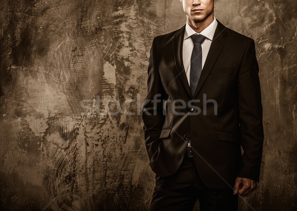 Well-dressed man in black suit against grunge wall  Stock photo © Nejron