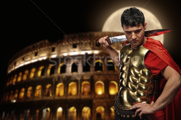 Roman legionary soldier in front of coliseum at night time Stock photo © Nejron