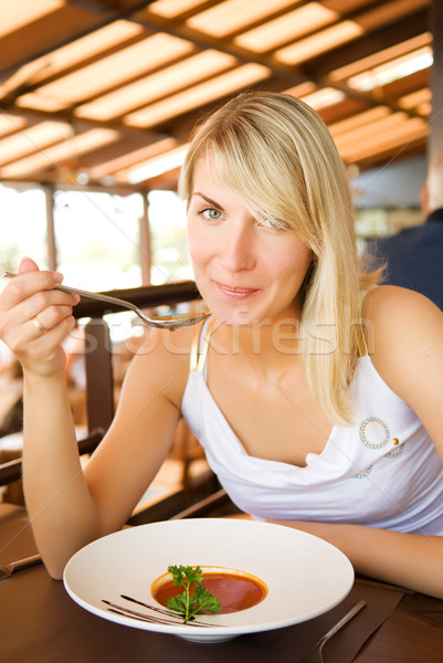 Jeune femme manger soupe à la tomate restaurant beauté table [[stock_photo]] © Nejron