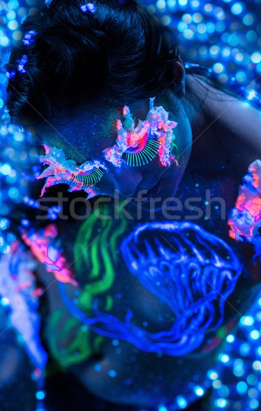 Beautiful woman with body art glowing in ultraviolet light Stock photo © Nejron