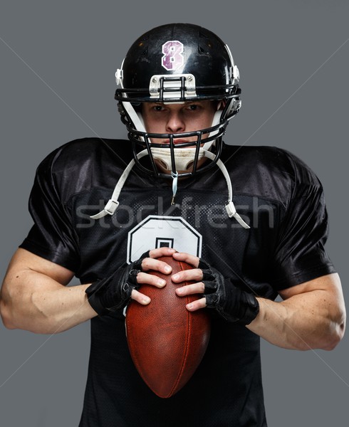 American football player with ball wearing helmet and jersey  Stock photo © Nejron