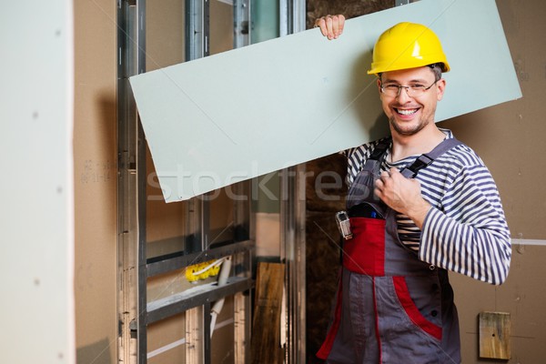 Builder with plasterboard in new building interior  Stock photo © Nejron