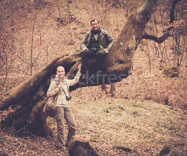 Happy smiling travellers couple in a forest Stock photo © Nejron