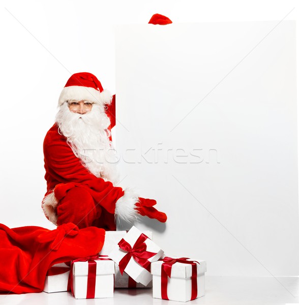 Santa Claus with sack full of gift boxes and blank notice board  Stock photo © Nejron
