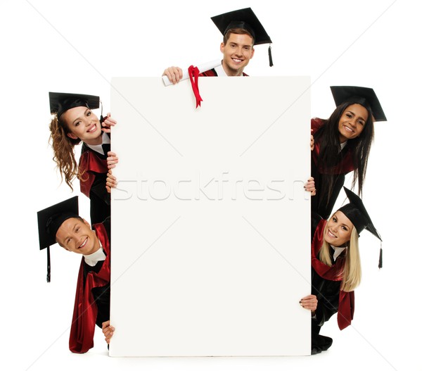 Multi ethnic group of graduated young students with blank notice board Stock photo © Nejron