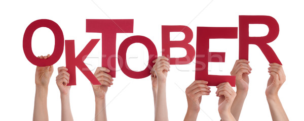 People Holding German Word Oktober Means October Stock photo © Nelosa