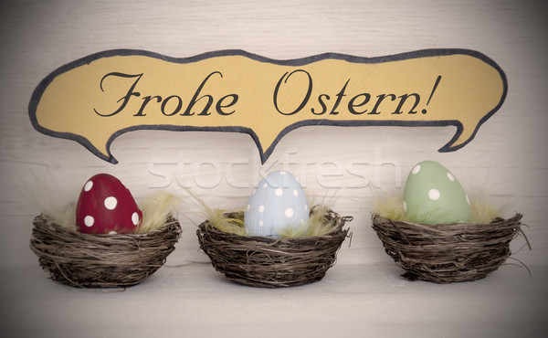 Spotlight To Three Colorful Easter Eggs With Comic Speech Balloon Frohe Ostern Means Happy Easter Stock photo © Nelosa