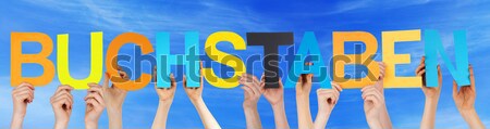 People Holding Colorful German Word Buchstaben Means Letters Blu Stock photo © Nelosa