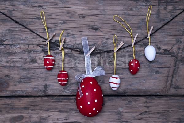 Many Red And White Easter Eggs And One Big Egg Hanging On Line Stock photo © Nelosa