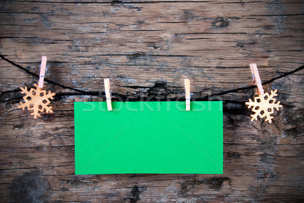 Empty Green Label with Snowflakes on a Line on Wood Stock photo © Nelosa