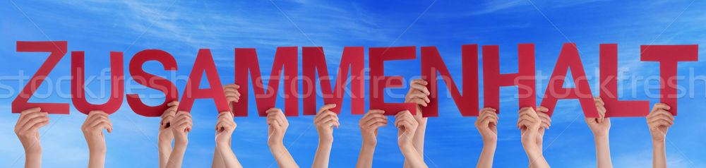 People Holding Straight German Word Zusammenhalt Means Solidarit Stock photo © Nelosa